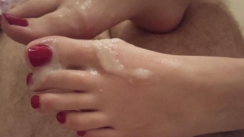 Horny teen gives feetjob and plays with cum