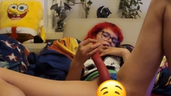 Your redheaded skinny girl makes herself comfortable on the couch with a vibrator and plug in her ass