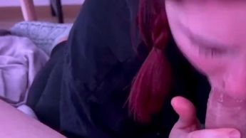 Close-up of a redhead giving a blowjob
