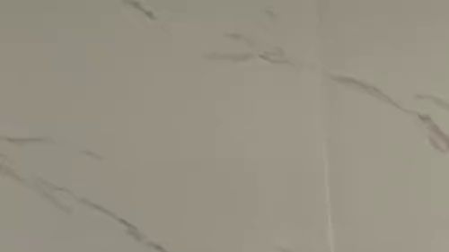 Hot blonde pampers herself in front of the mirror